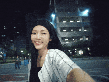 a woman taking a selfie in front of a building