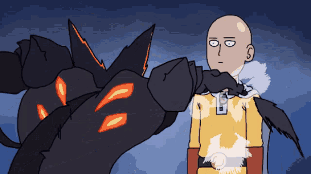 a bald man in a yellow shirt is standing next to a black monster
