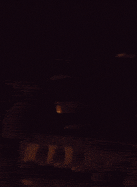 a blurred image of a person 's face in the dark
