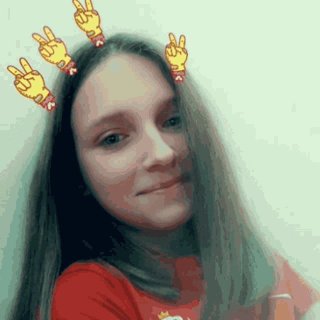 a girl wearing a red shirt with a crown on it