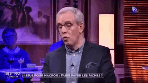 a man in a suit and glasses is on a television show called bistro libertes