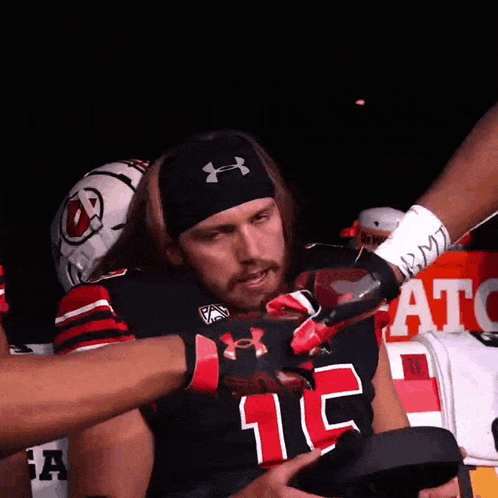 a man wearing a black under armour headband and a jersey with the number 11 on it