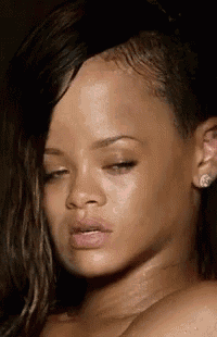 a close up of a woman 's face with her eyes closed and her hair wet .