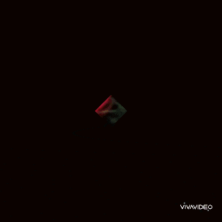 a woman in a red dress is laying in the grass with a vivavideo logo in the corner