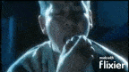 a blurred image of a man covering his face with his hands