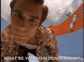 a close up of a man 's face with the words `` what 're you doin down there '' written on the bottom .