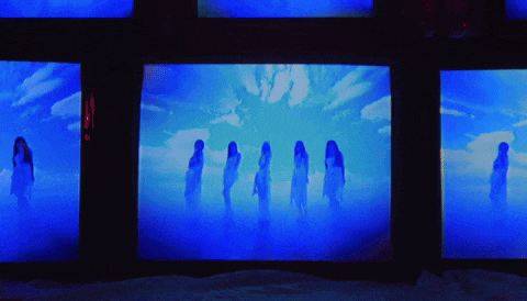 a group of women are standing in front of a blue sky