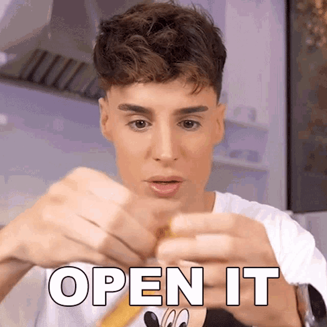 a man is holding a piece of food in his hands with the words open it written on it .