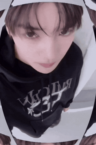 a close up of a person wearing a black hoodie that says ' a ' on it