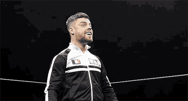 a man wearing a black and white jacket with the word oslin on the front
