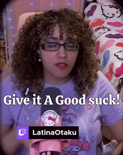 a woman with curly hair is holding a microphone and says give it a good suck latinaotaku
