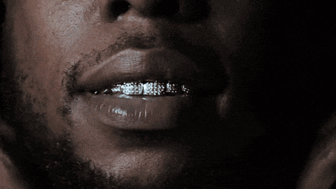 a close up of a man 's mouth with grills