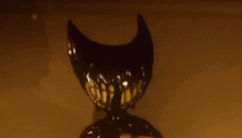 a close up of a cartoon character with horns and a big smile .