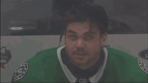 a man in a green jersey with the word ford on the side