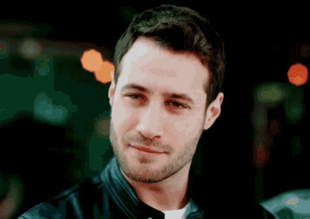 a man with a beard wearing a leather jacket