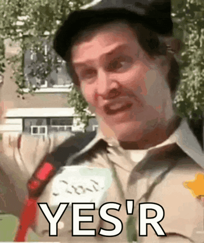 a man in a hat is holding a sign that says yes r