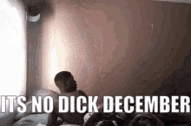a man is laying on top of a woman on a bed with the words `` it 's no dick december '' .