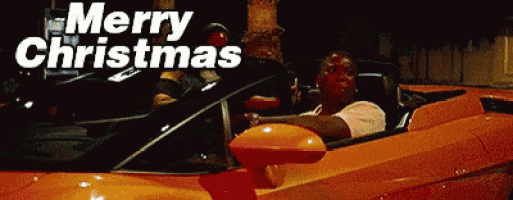 a man is driving a sports car with the words merry christmas written above him