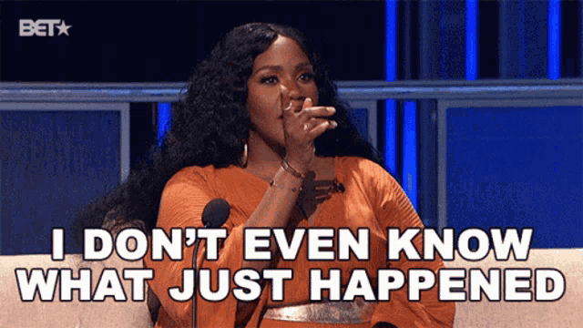 a woman is sitting in front of a microphone and says i don 't even know what just happened