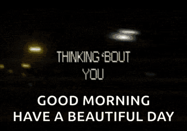 a good morning message with a blurred image of a sign that says `` thinking bout you '' .