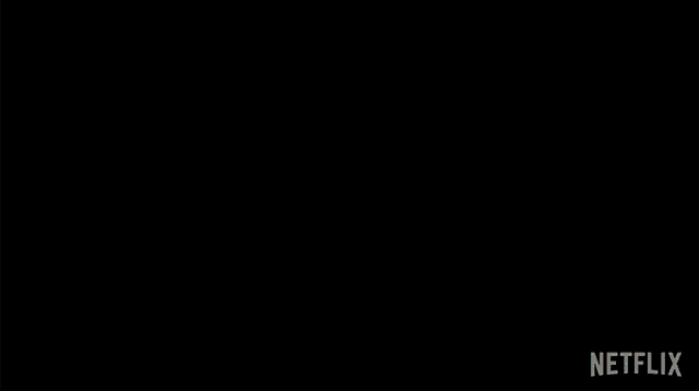a woman in a white tank top is standing in front of a black background that says netflix on it