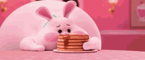 a bunny is sitting at a table eating pancakes .