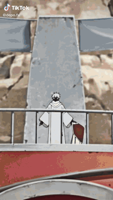 a man in a white robe is standing in front of a fence with a banner that says tik tok