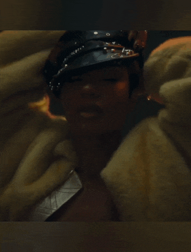 a close up of a woman wearing a fur coat
