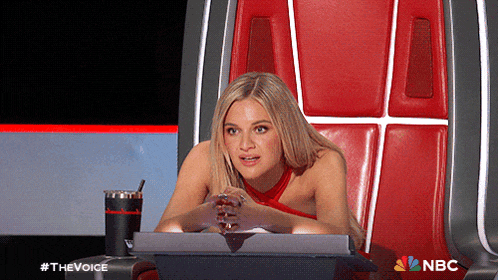 a woman sits in a chair with a nbc logo on the bottom right