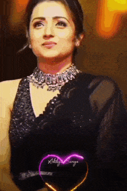 a woman in a black dress with a heart that says ' aditya sannya ' on it