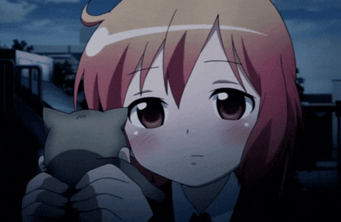 a girl with red hair is holding a small cat