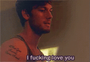 a man with a tattoo on his arm is smiling and saying i fucking love you