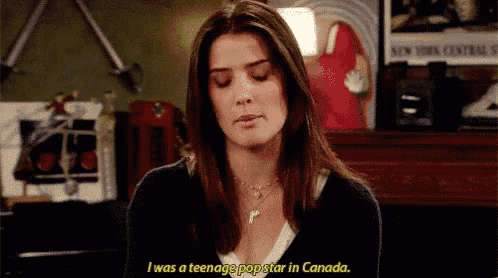 a woman is sitting in a room with her eyes closed and talking about being a teenage pop star in canada .