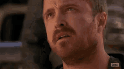 a close up of a man 's face with a beard making a funny face .