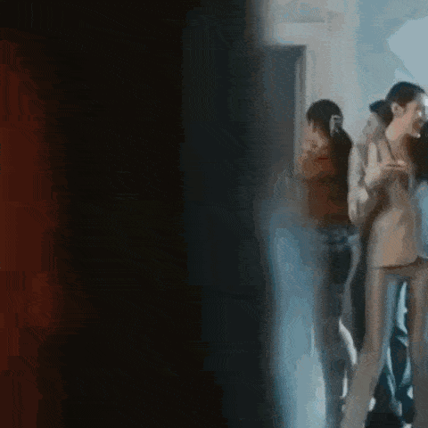a group of people are standing next to each other in a room .