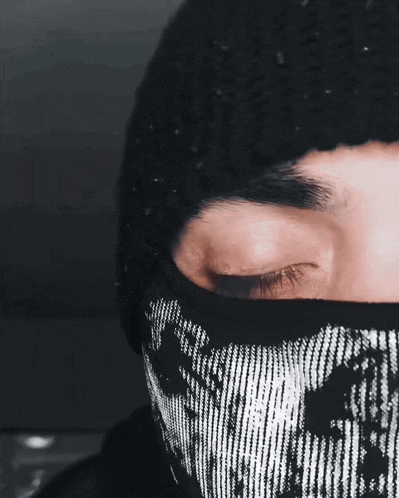 a close up of a person wearing a mask with their eyes closed