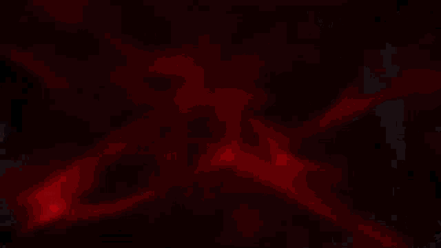 a close up of a red light coming out of a dark room .