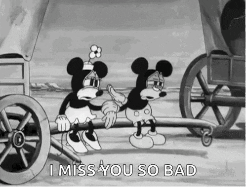 mickey mouse and minnie mouse are sitting on a wagon pulled by a horse drawn carriage .