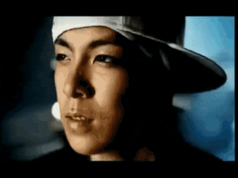 a close up of a man wearing a hat and bandana