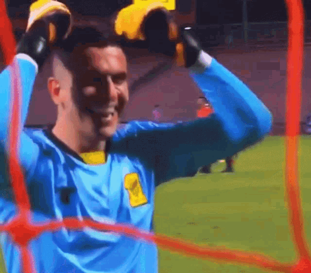 a soccer player wearing a blue jersey with a yellow emblem on the front