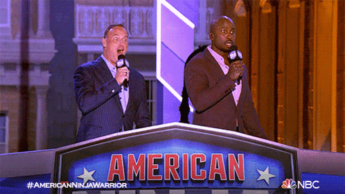 two men stand behind a podium that says american