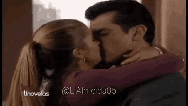 a man and a woman are kissing and hugging each other