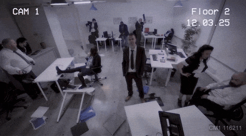 a group of people are standing in an office with cam 1 and cam 2 displayed