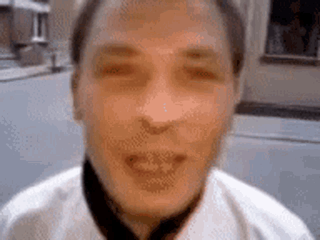 a close up of a man 's face with a blurred background .
