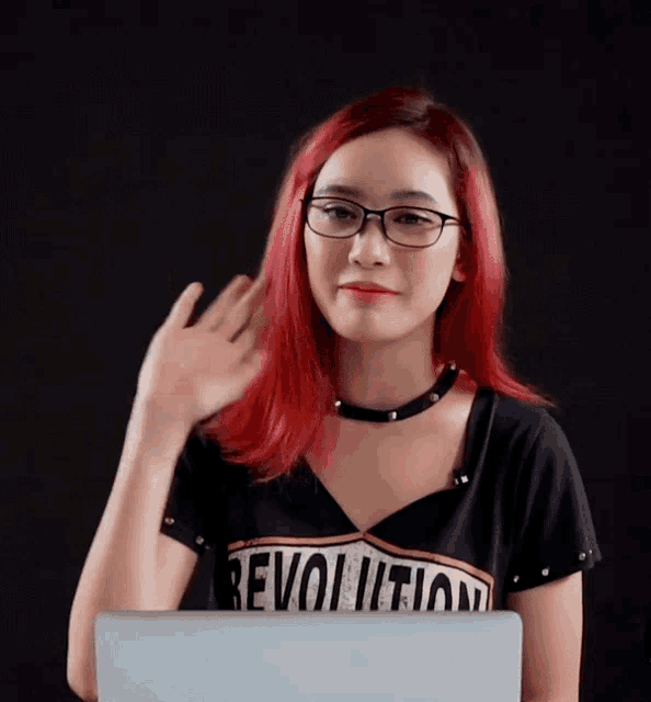 a woman with red hair is wearing a revolution t-shirt