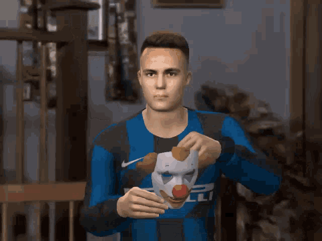 a man wearing a clown mask and a blue shirt with a star on it