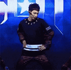 a man in a black shirt and brown pants is dancing