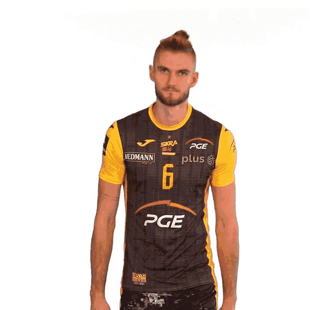 a man wearing a black and yellow shirt with the number 6 on it