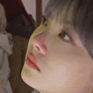 a close up of a woman 's face with a yellow mask on her nose