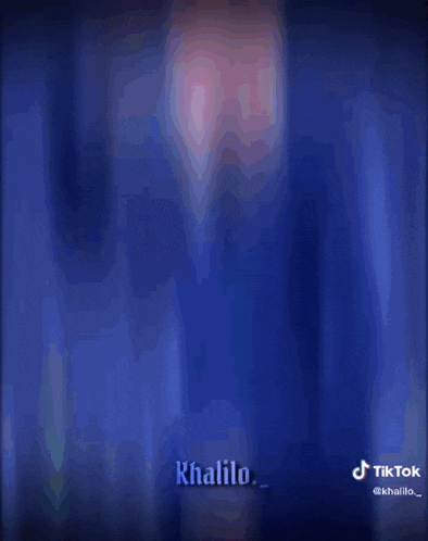 a man in a blue suit is holding his hand to his head
